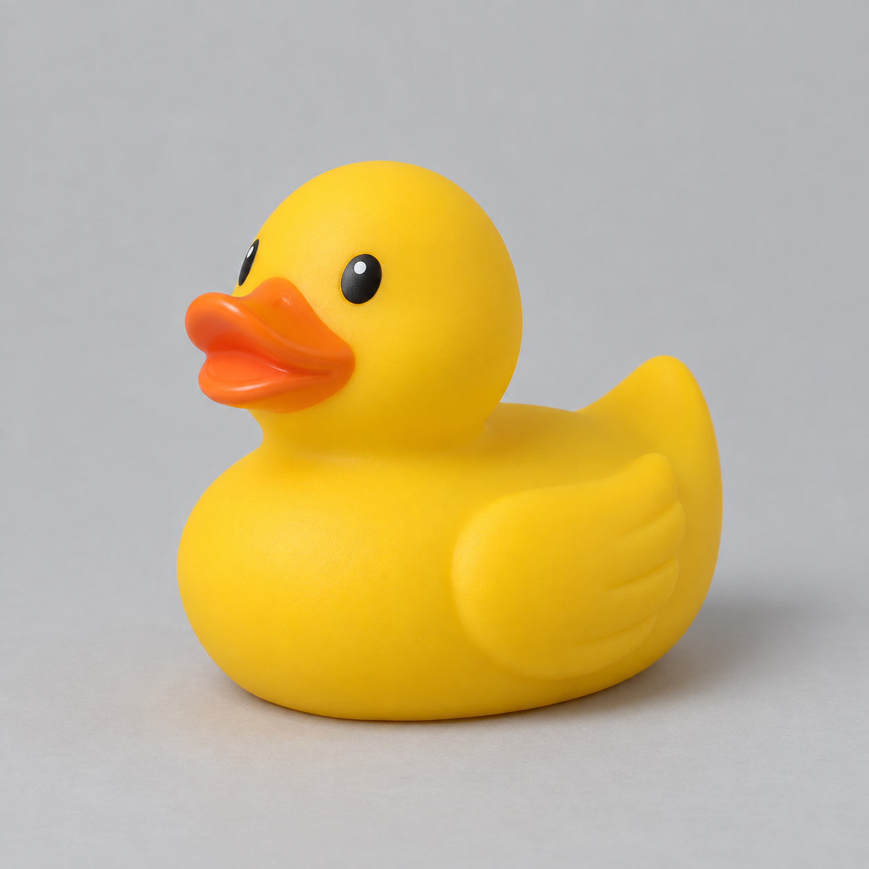 AI-generated yellow rubber duck reference showing its orange beak, black eyes, raised wing, and upturned tail from a three-quarter view